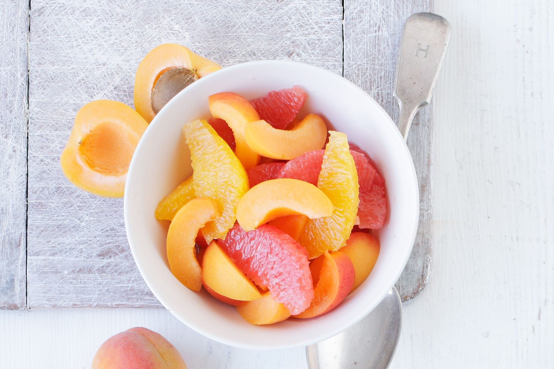 Grapefruit, orange, and apricot salad in a bowl.