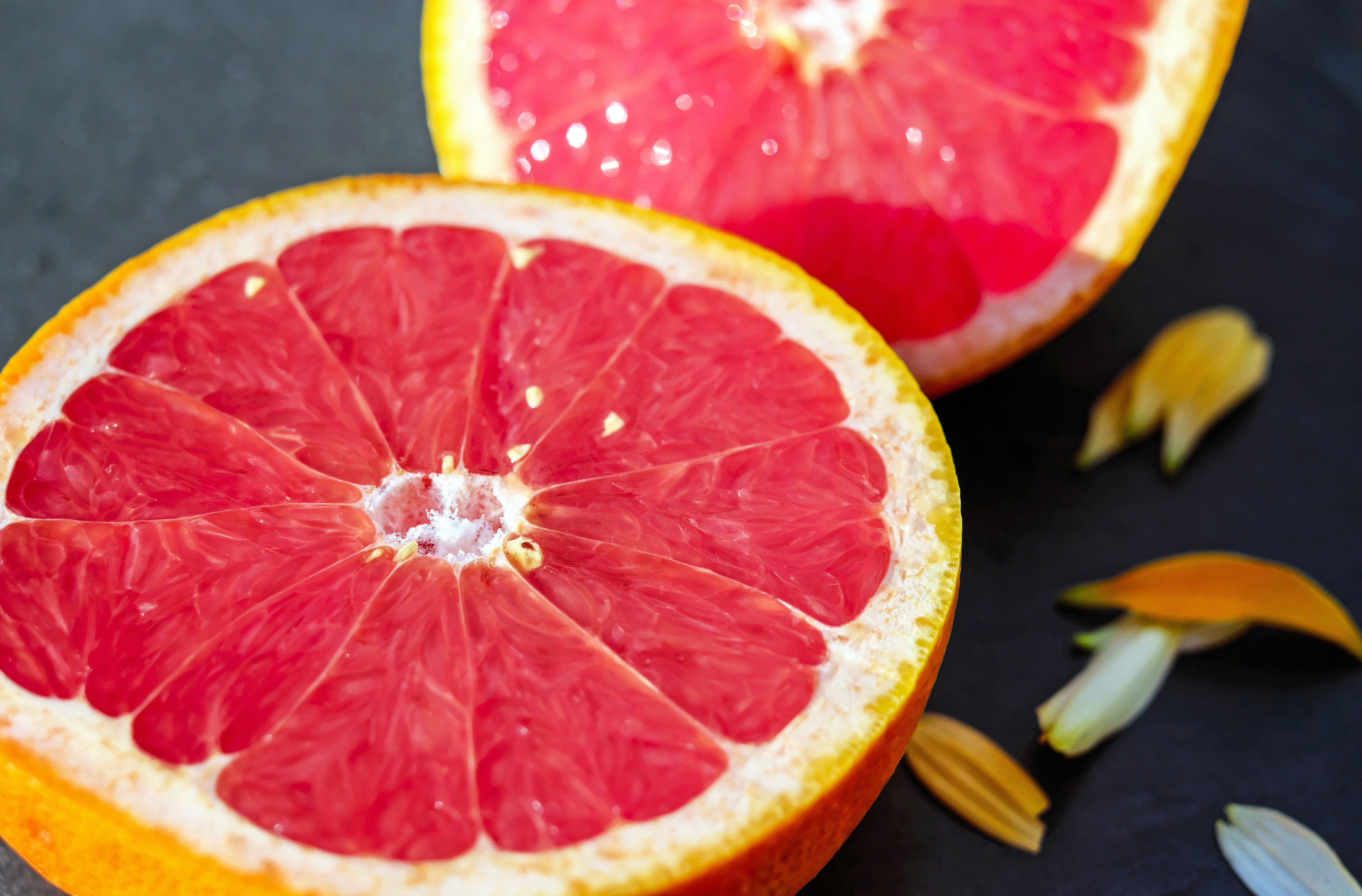 A vibrant display of fresh grapefruit halves, showcasing their juicy pulp and inviting aroma