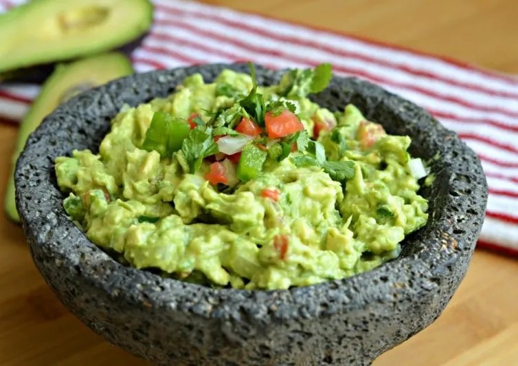 Authentic guacamole made in a molcajete, a traditional Mexican mortar and pestle