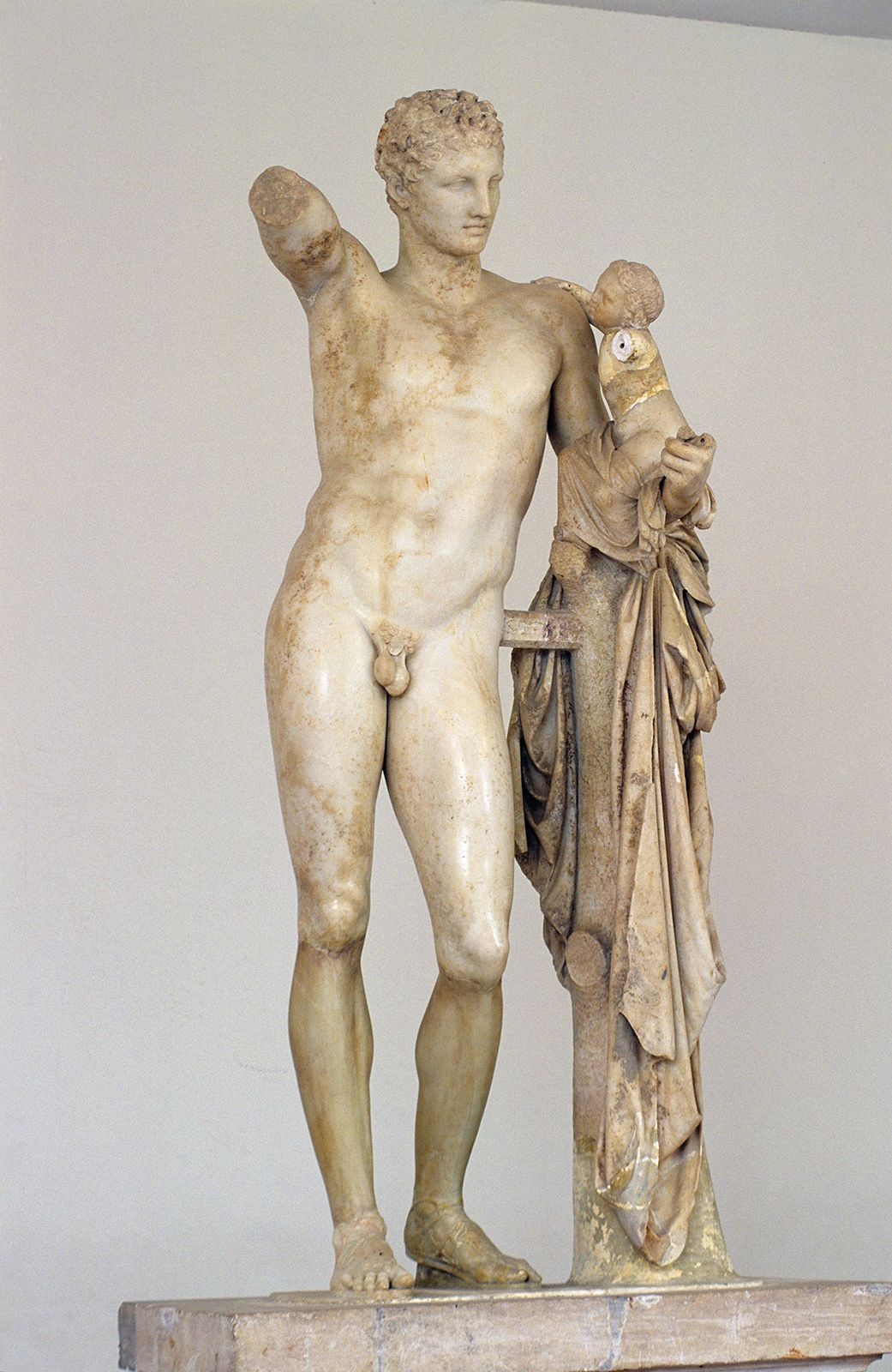 Hermes Carrying the Infant Dionysus, marble statue by Praxiteles, showcasing the divine origins and upbringing of the god of wine and revelry