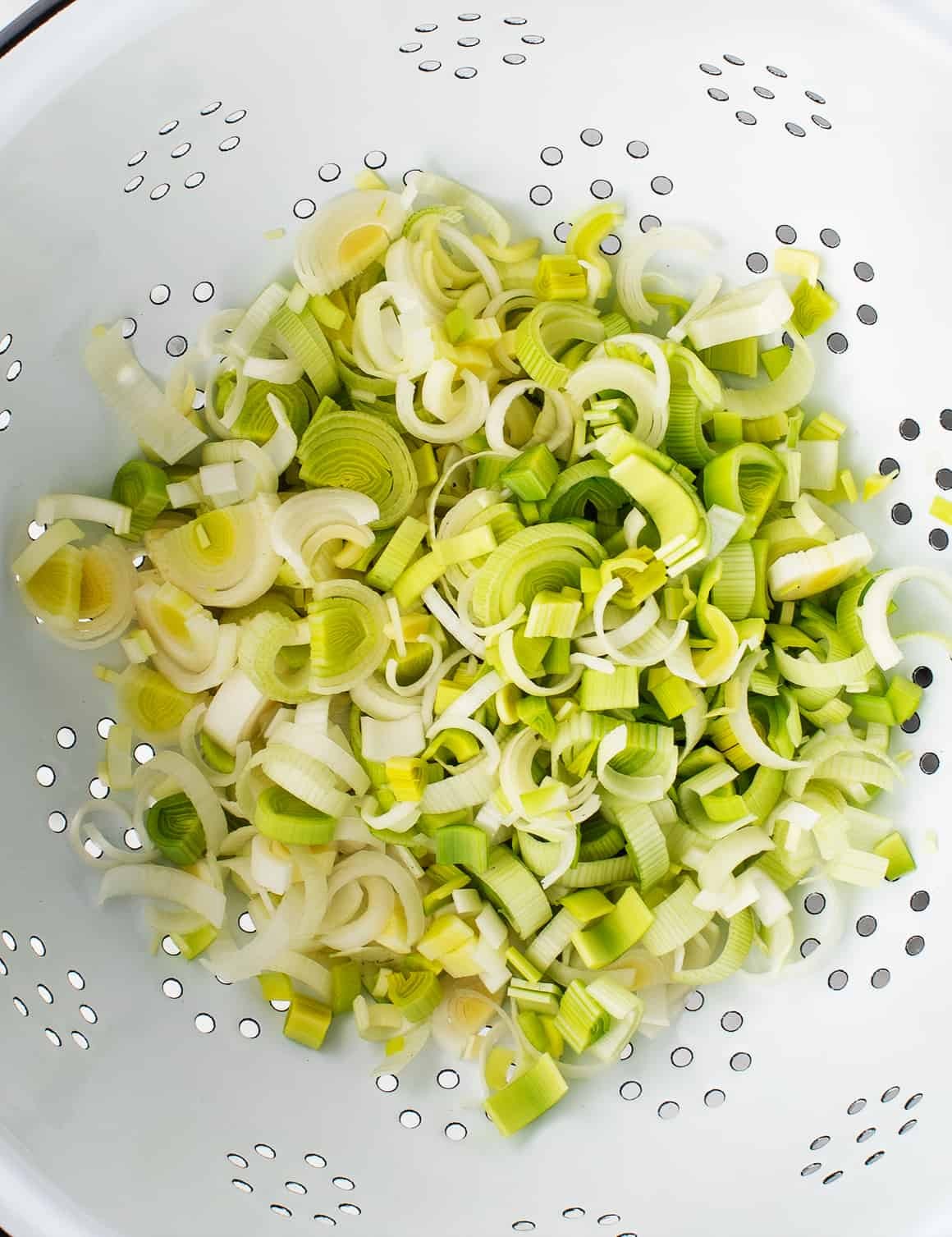 Chopped leeks in a colander
