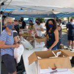 Volunteers distributing food at a food giveaway