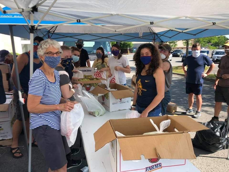 Volunteers distributing food at a food giveaway