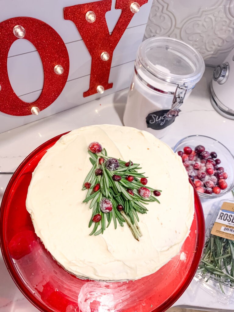 Christmas Tree Cake decorated with rosemary and cranberries for a festive dessert