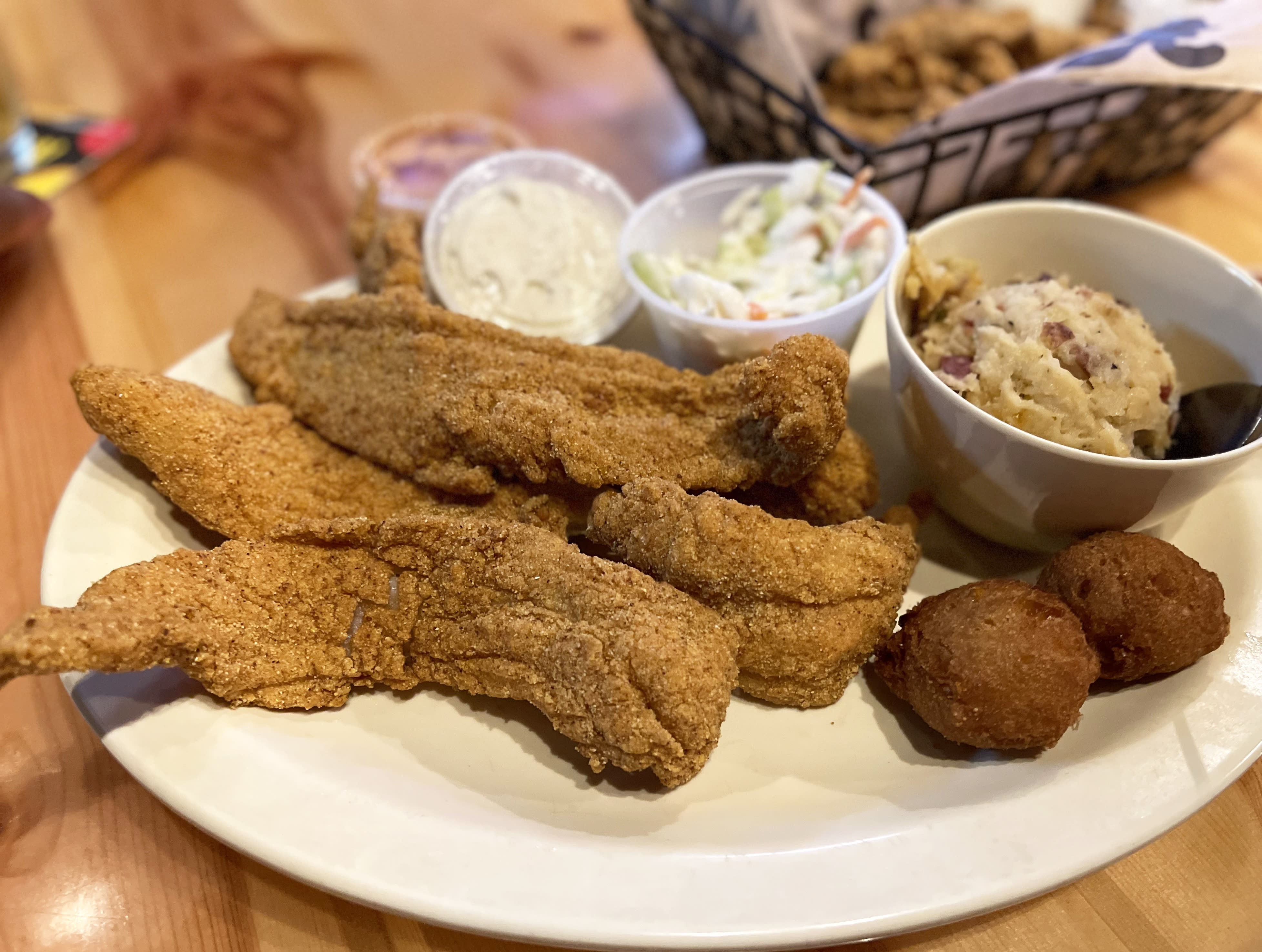 Fried duck and fish plate from Crazy Cajun showcasing the restaurant's authentic Cajun cuisine