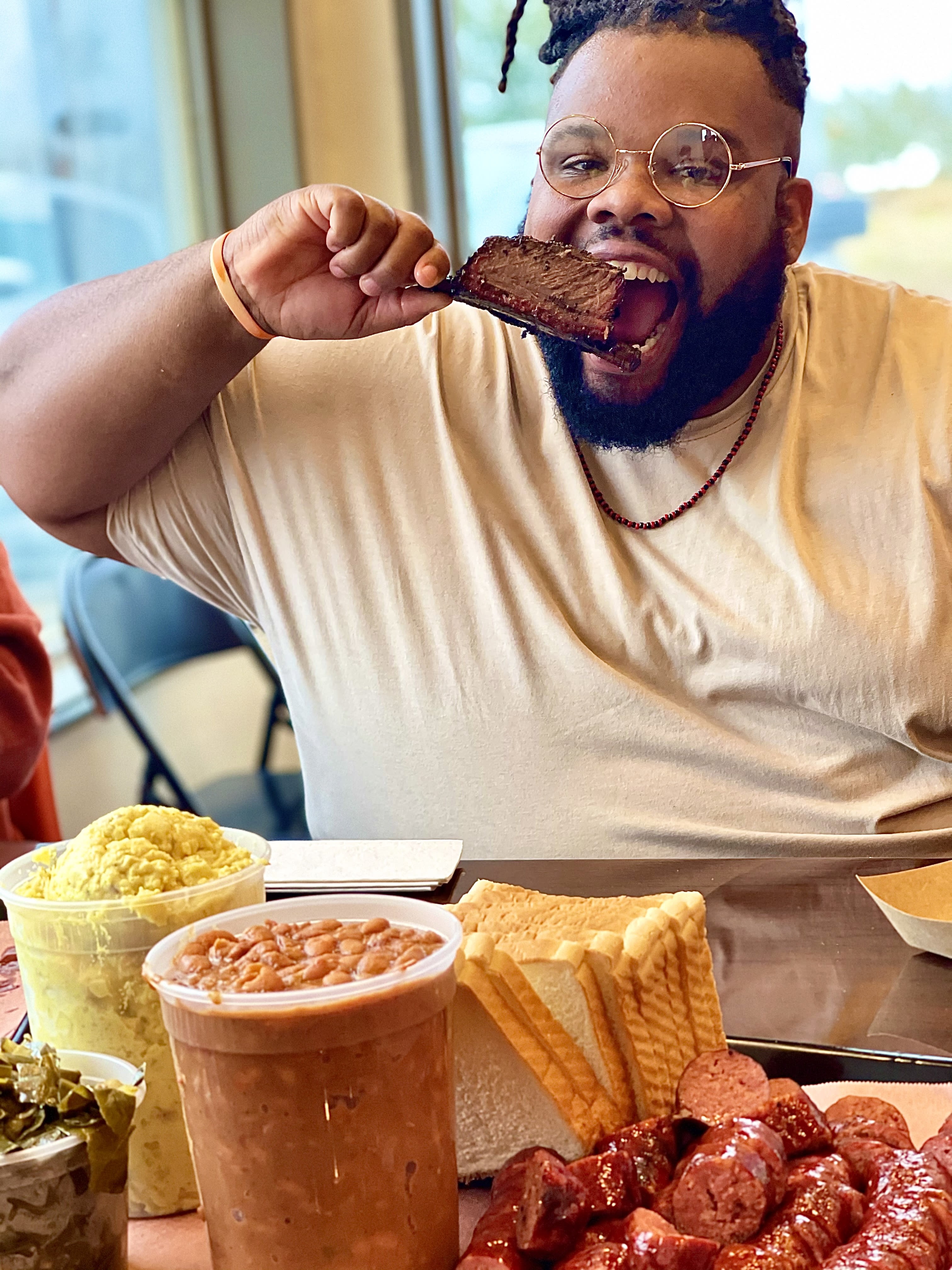 Jeff eating BBQ from 1701 Barbeque showcasing a platter of smoked meats