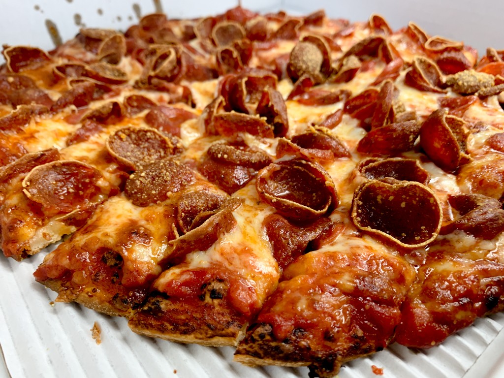 Columbus-style pizza with thin crust and generous pepperoni