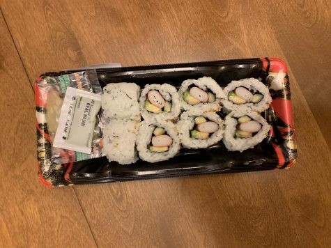 Selection of sushi rolls on display in a refrigerated case at Whole Foods Market, highlighting the pre-made nature and variety available.