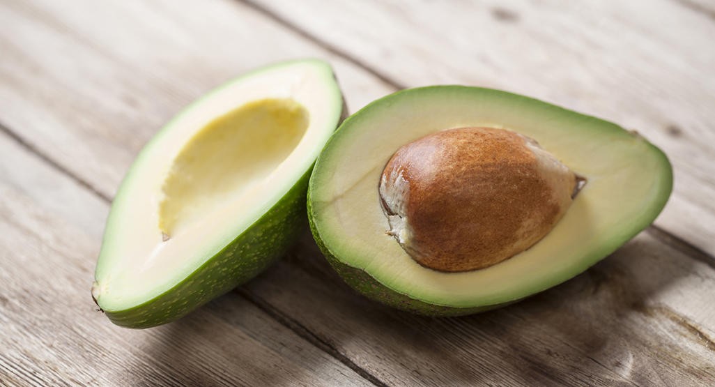 Mashed avocado in a small bowl, ready for baby consumption