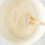 Dry ingredients for Jamaican festival being mixed in a bowl