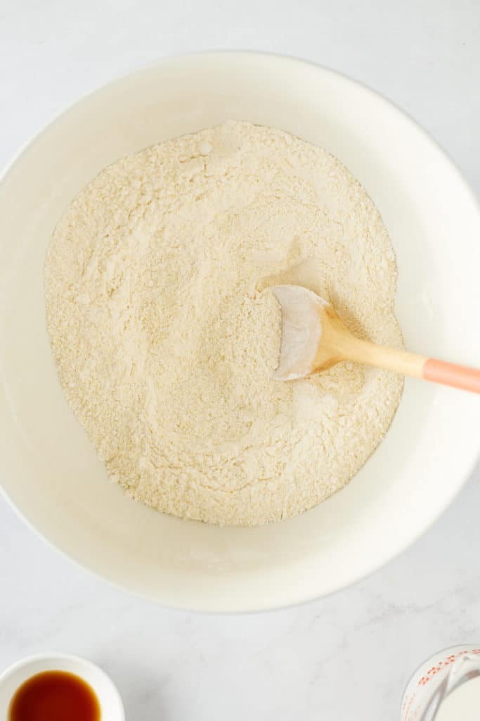 Dry ingredients for Jamaican festival being mixed in a bowl