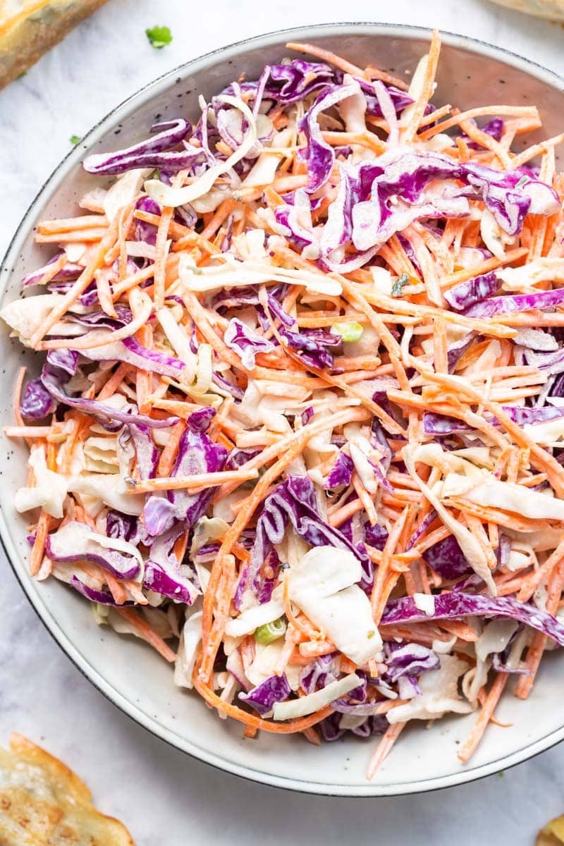 Close-up of keto coleslaw with creamy dressing and vibrant vegetables.