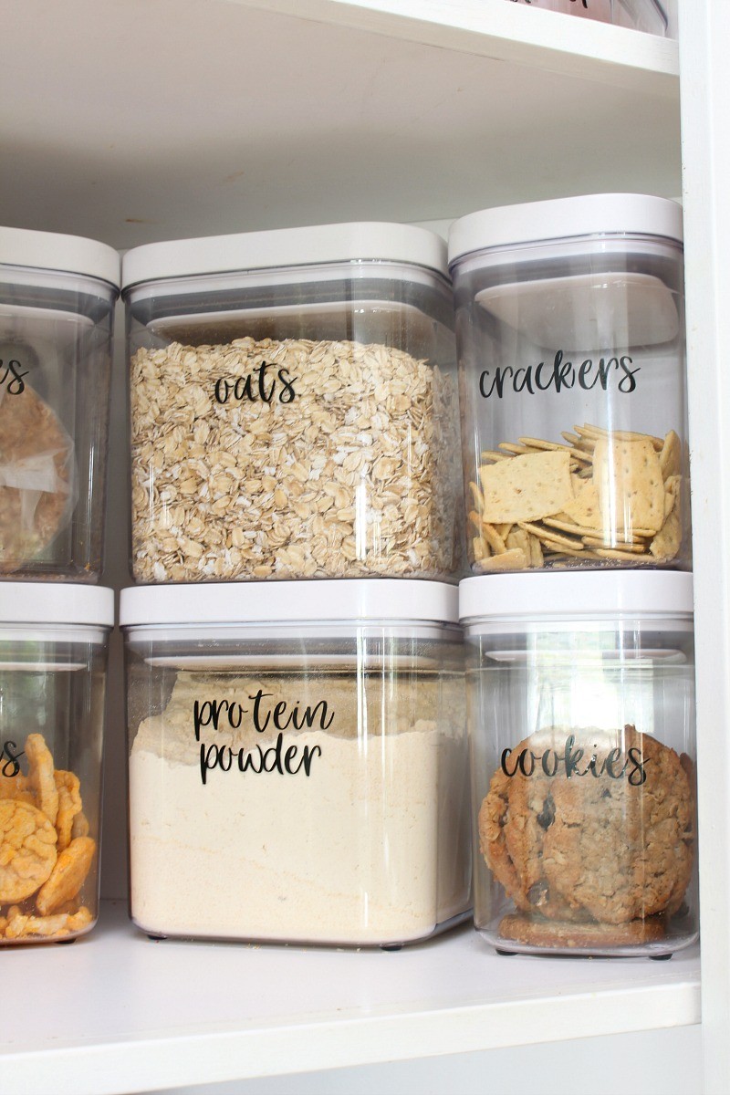 Kitchen cabinet organization with OXO storage bins and vinyl labels