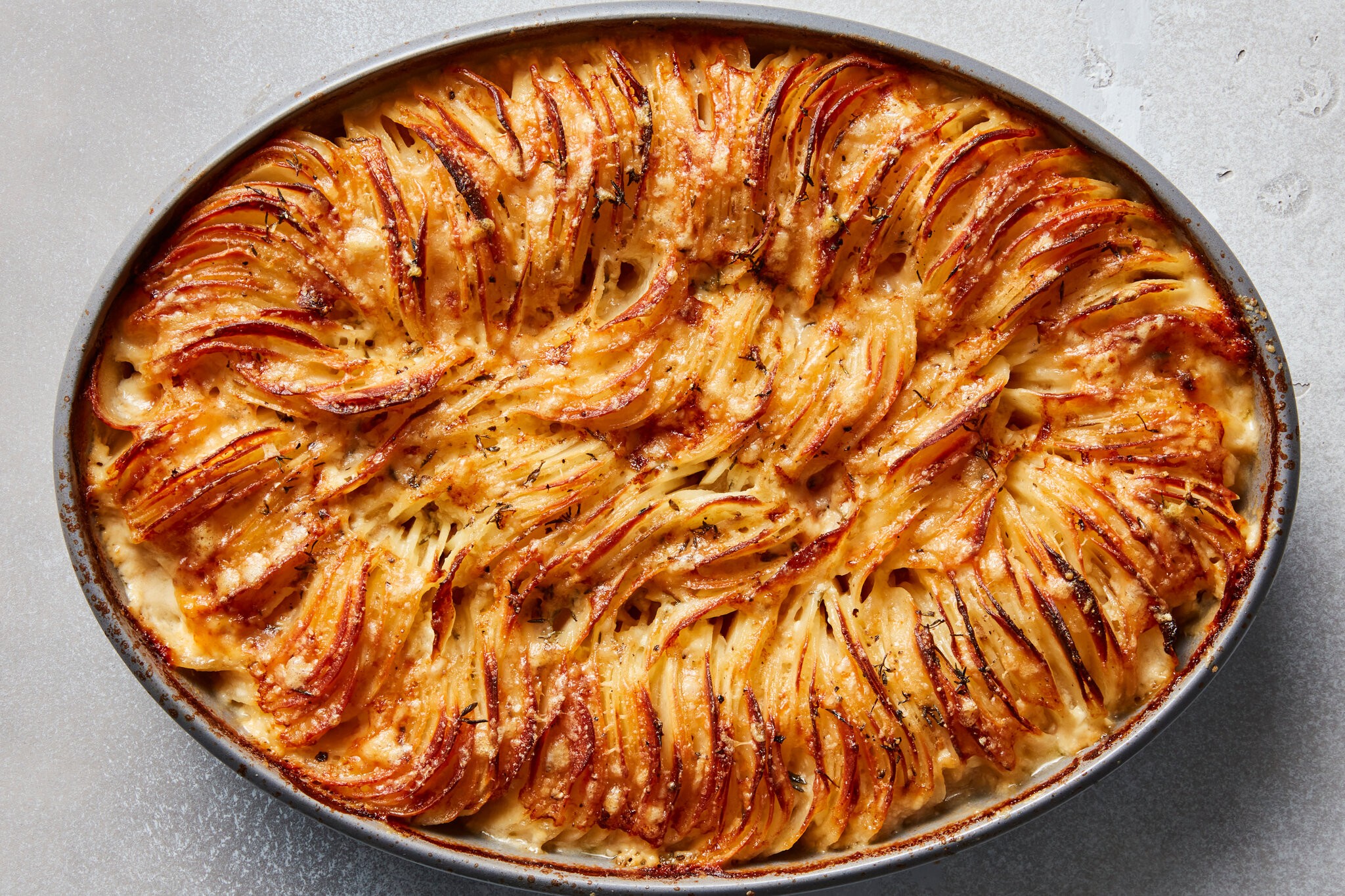 Cheesy Hasselback potato gratin with melted browned cheese, packed and ruffly potatoes