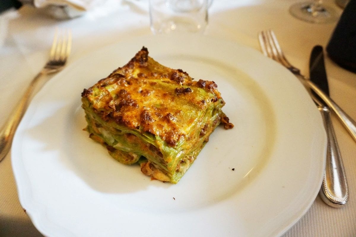 A White Plate with Green Lasagna