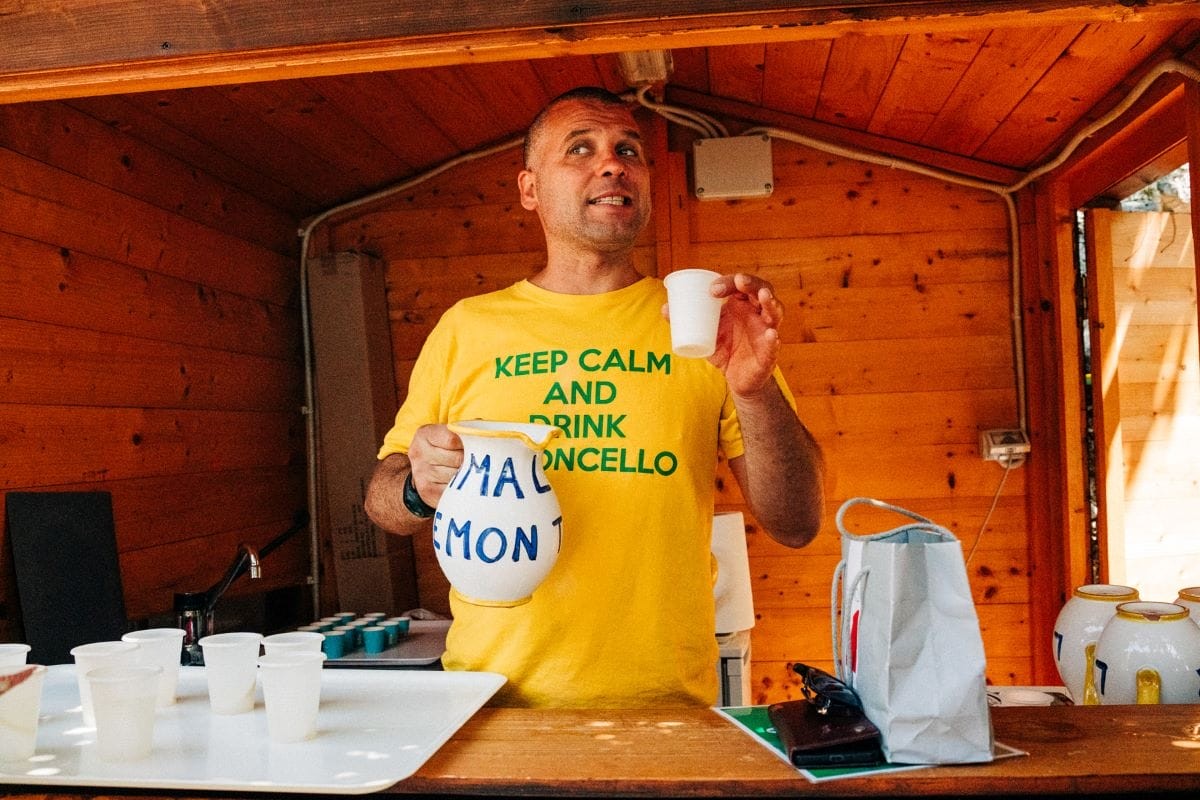 Man in Yellow Shirt Holding a Glass of Limoncello