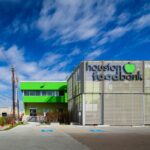 Volunteers assist in sorting and packing donations at the Houston Food Bank, reflecting its commitment to fighting hunger
