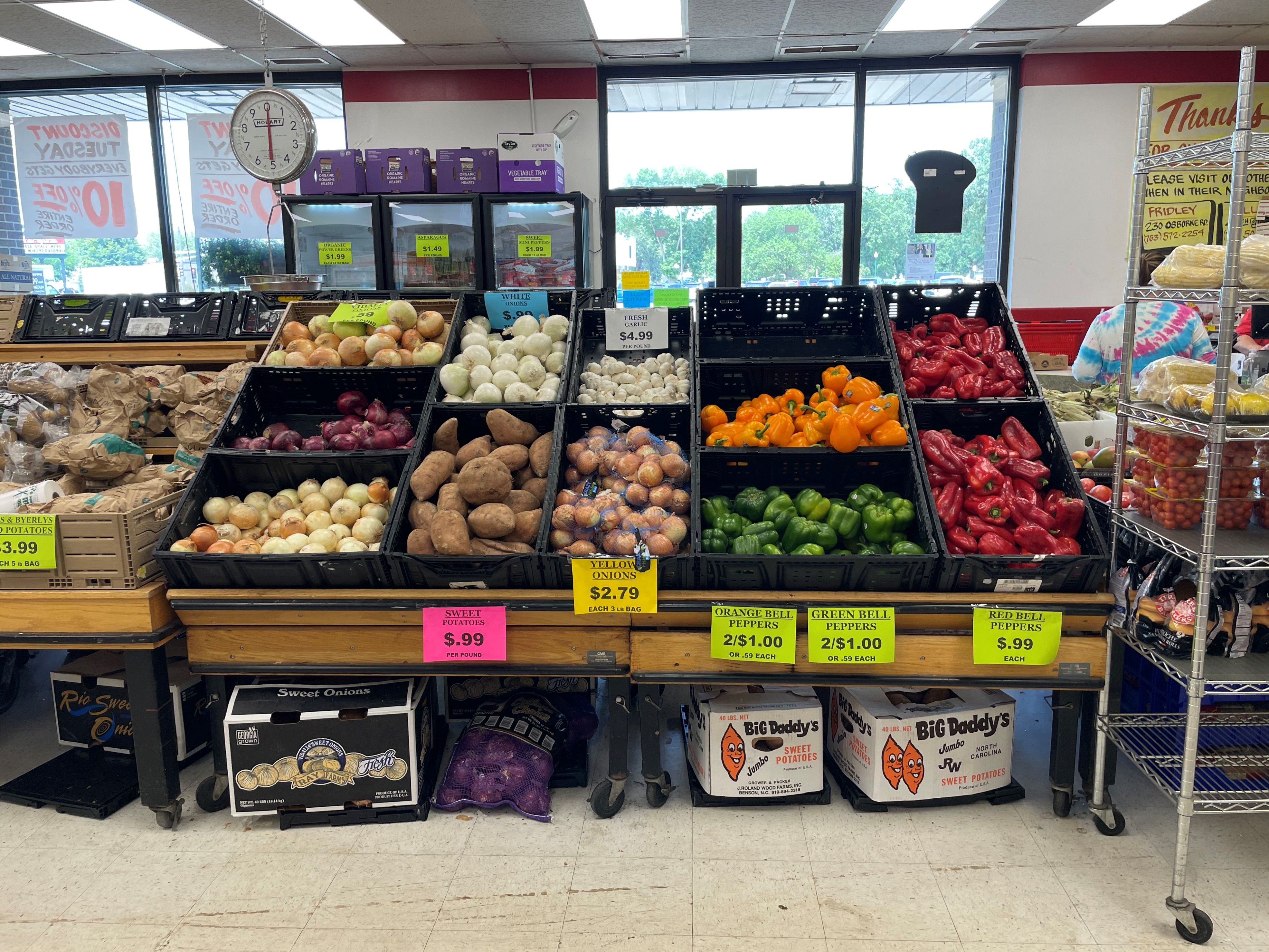 Produce section at Mike's Discount Foods, showcasing fresh apples, potatoes, and peppers with discount pricing
