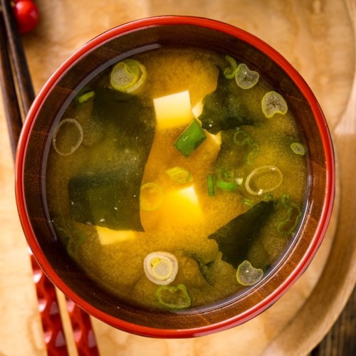 A Japanese miso soup bowls containing tofu and wakame miso soup.
