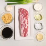 Raw pork loin on a wooden cutting board.
