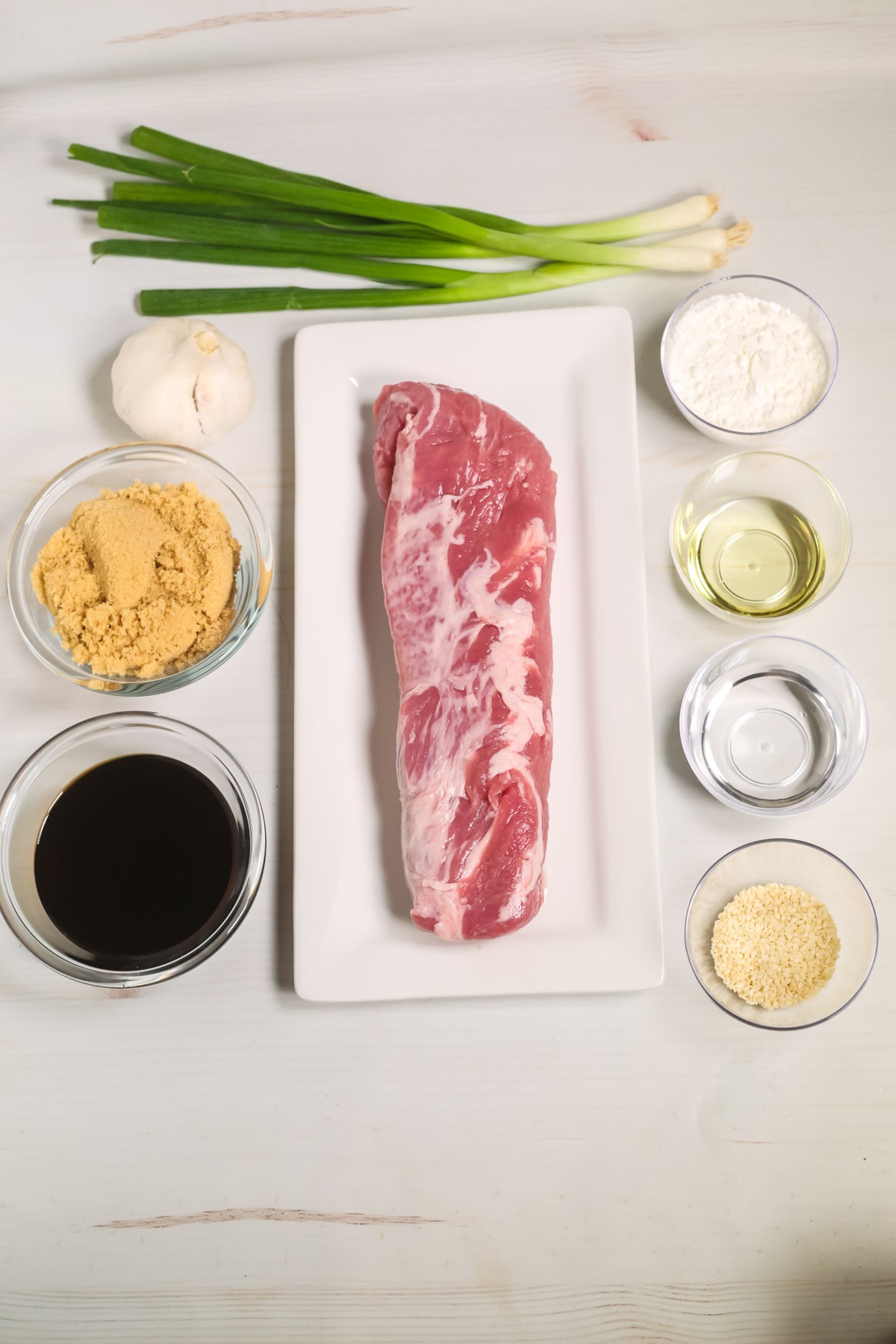 Raw pork loin on a wooden cutting board.