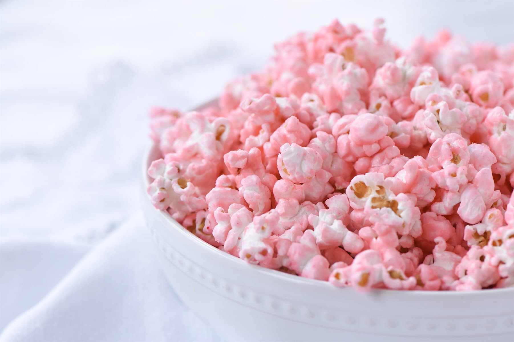 Side view of a bowl of pink popcorn