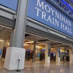 Interior view of Moynihan Train Hall with sign indicating its name.