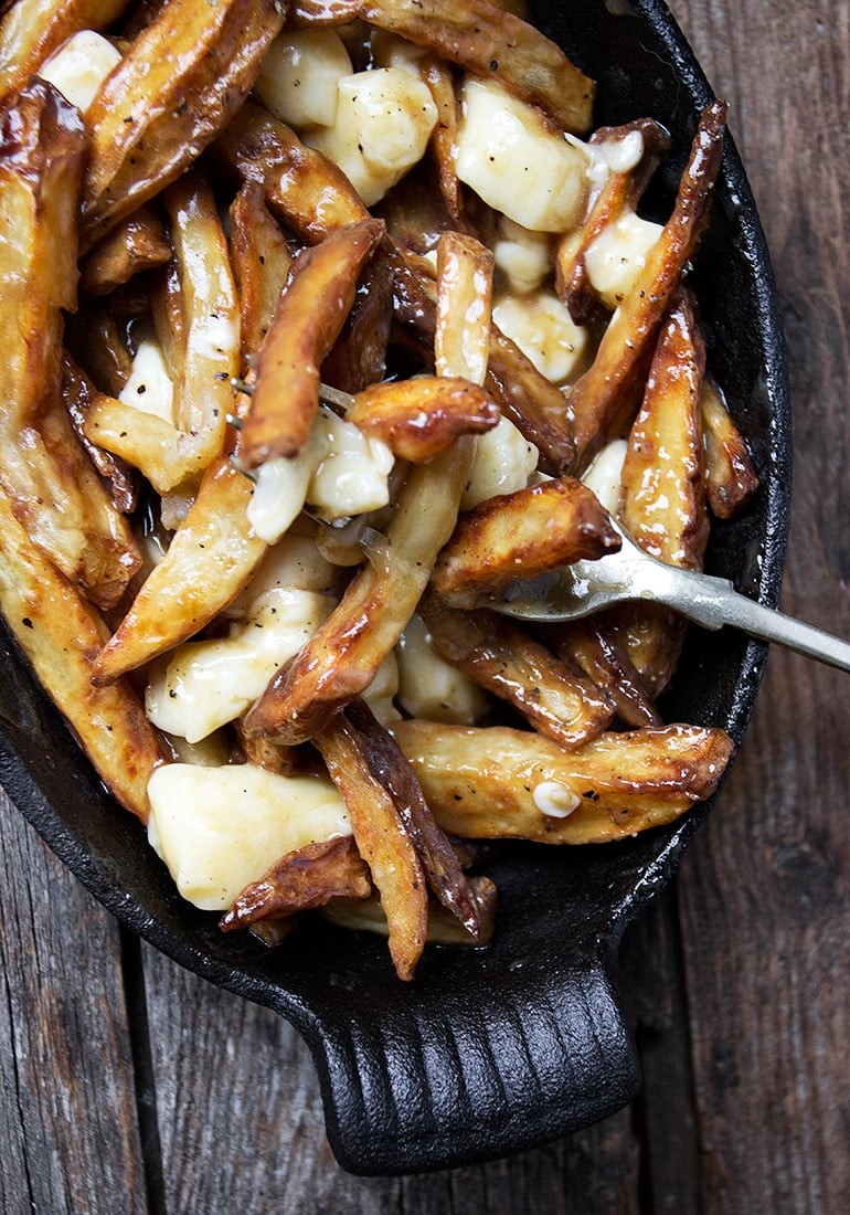 A close-up of cheese curds on a plate, showcasing their fresh and squeaky texture