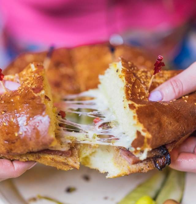 Muffuletta, an Italian sandwich invented in New Orleans, blends cured meats, cheese, and olive dressing for a remarkable flavor