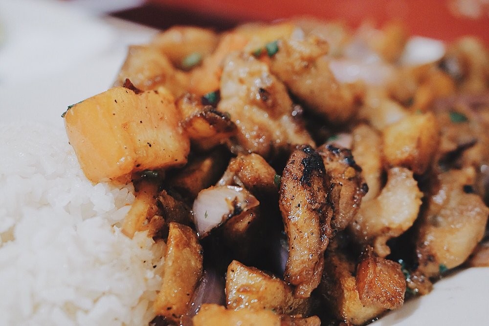 Lomo Saltado Peruvian stir-fry with beef, onions, tomatoes, and french-fried potatoes.