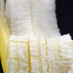 Close-up of a peeled banana, highlighting its texture and color.