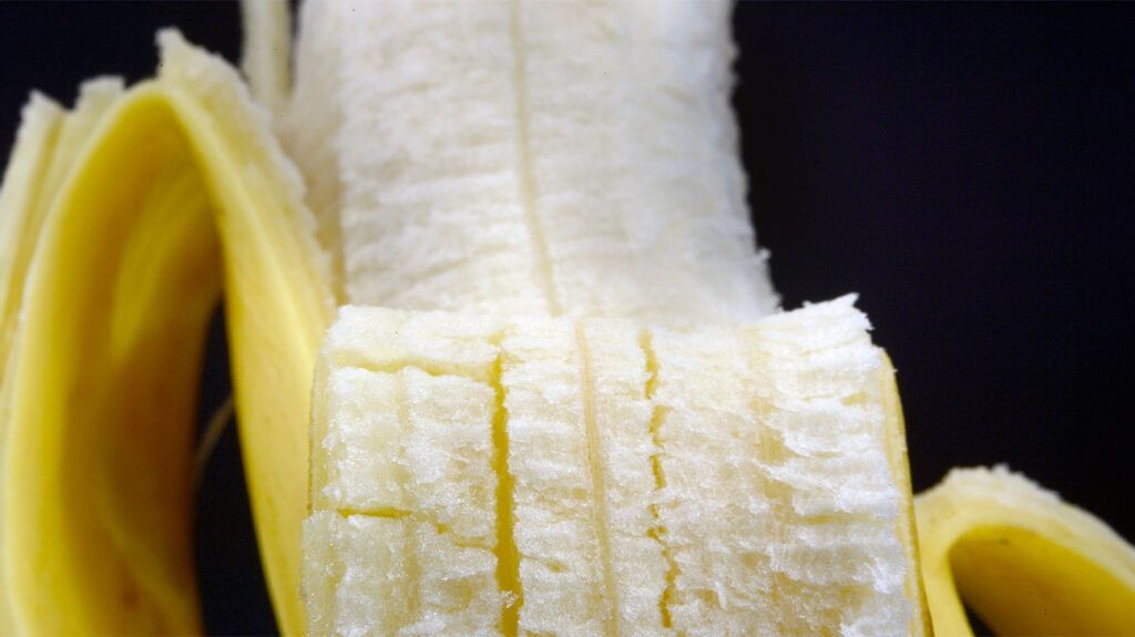 Close-up of a peeled banana, highlighting its texture and color.
