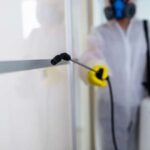 Pest control professional inspecting a kitchen.