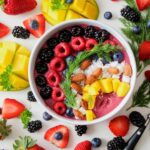 A colorful and healthy salad with mixed greens, avocado, and various vegetables
