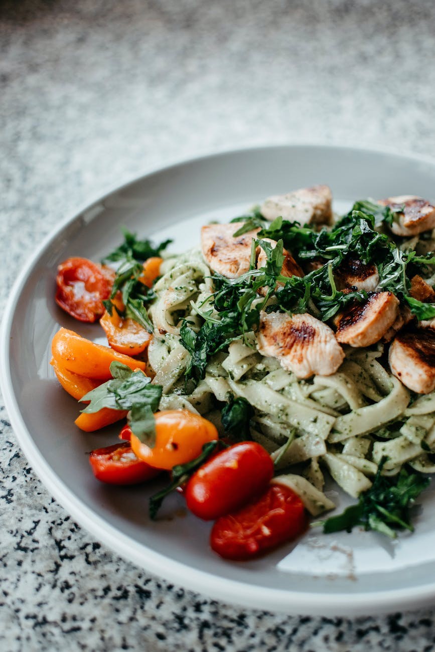 a plate of food with noodles, vegetables, and meat