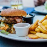 Assortment of foods to avoid with acidity such as fried foods, citrus fruits, and spicy dishes