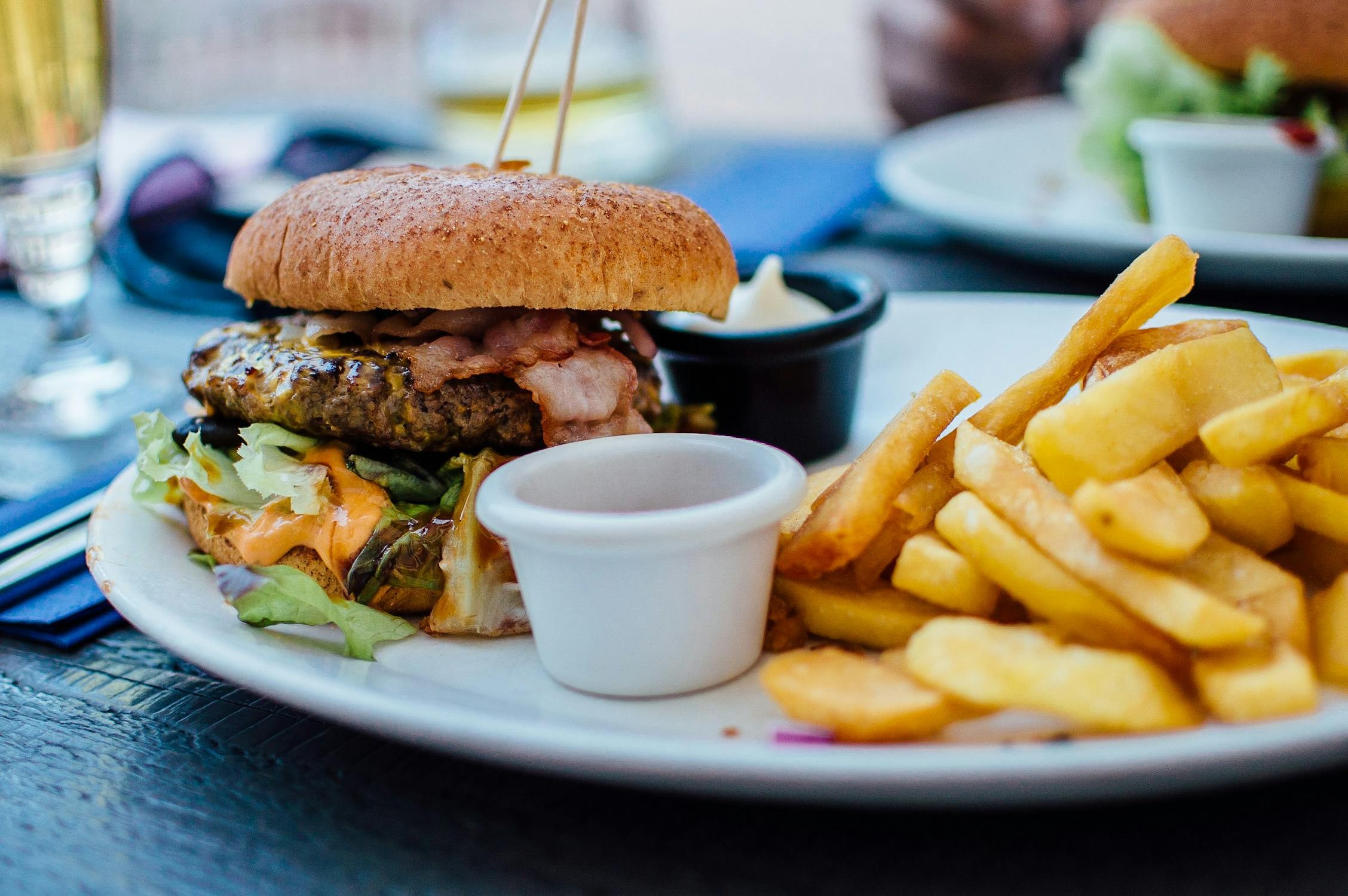 Assortment of foods to avoid with acidity such as fried foods, citrus fruits, and spicy dishes
