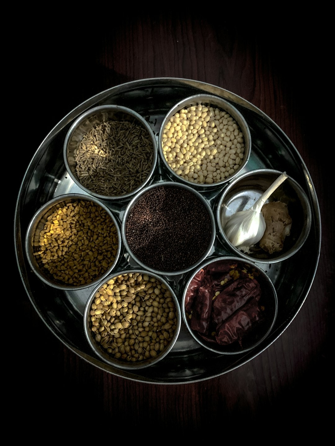 Colorful assortment of Indian spices in bowls, showcasing the variety beyond just chili peppers