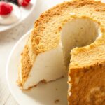 Angel food cake ingredients with focus on eggs, sugar, and flour, highlighting the absence of dairy.