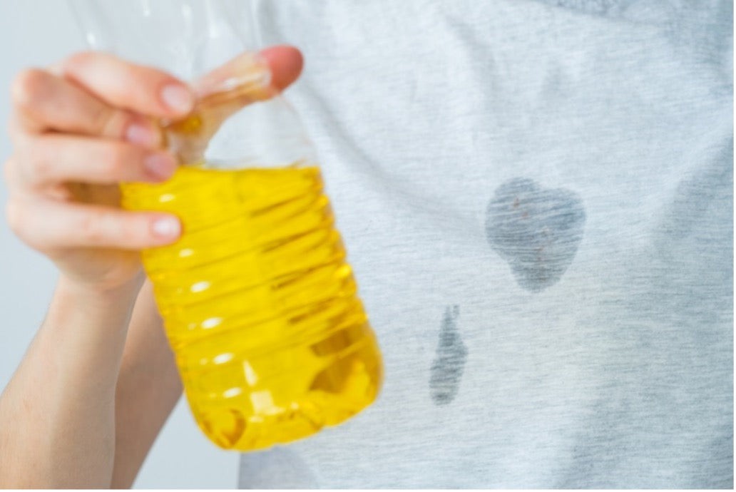 Woman cleaning food grease stain from clothes using baking soda