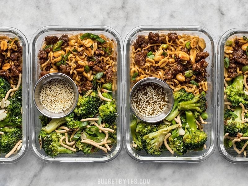 Assortment of meal prep containers filled with various foods.