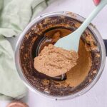 Close-up of a spoonful of almond butter on a wooden table