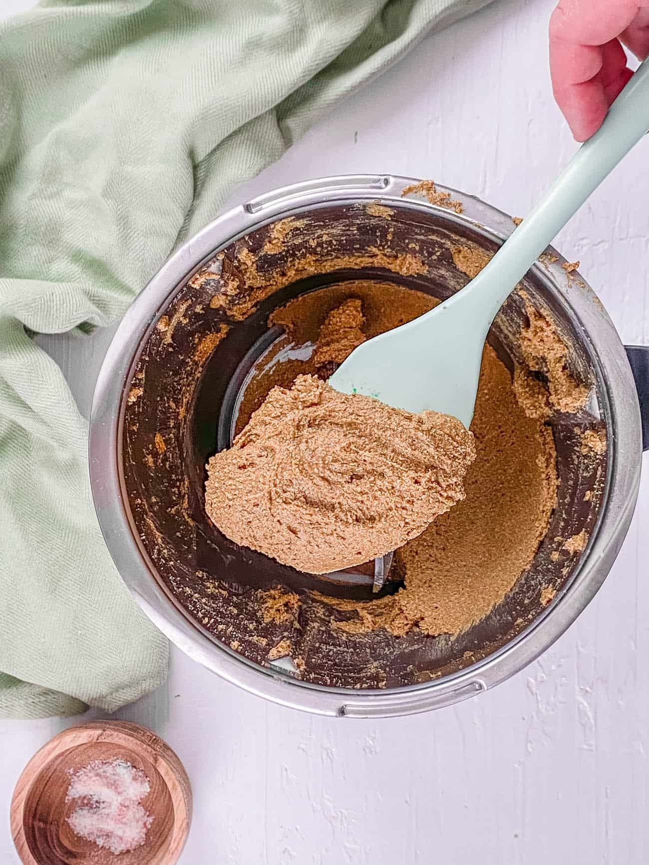 Close-up of a spoonful of almond butter on a wooden table