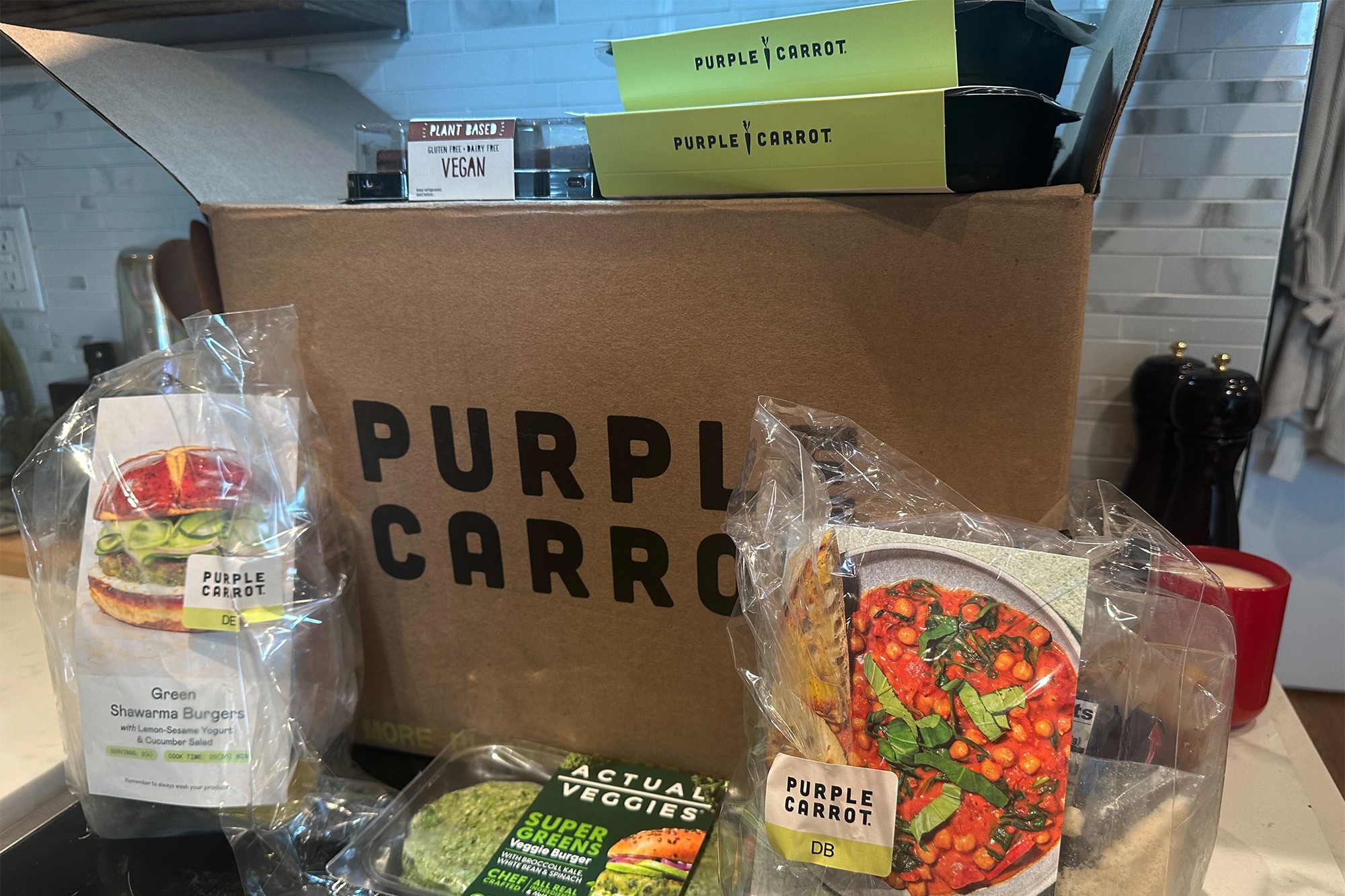 A box filled with food featuring a purple carrot
