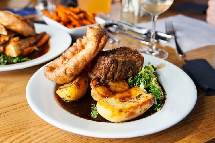 Vegetarian Sunday roast with nut roast, potatoes, and Yorkshire pudding