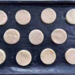 French biscuits cut in rounds on a baking tray