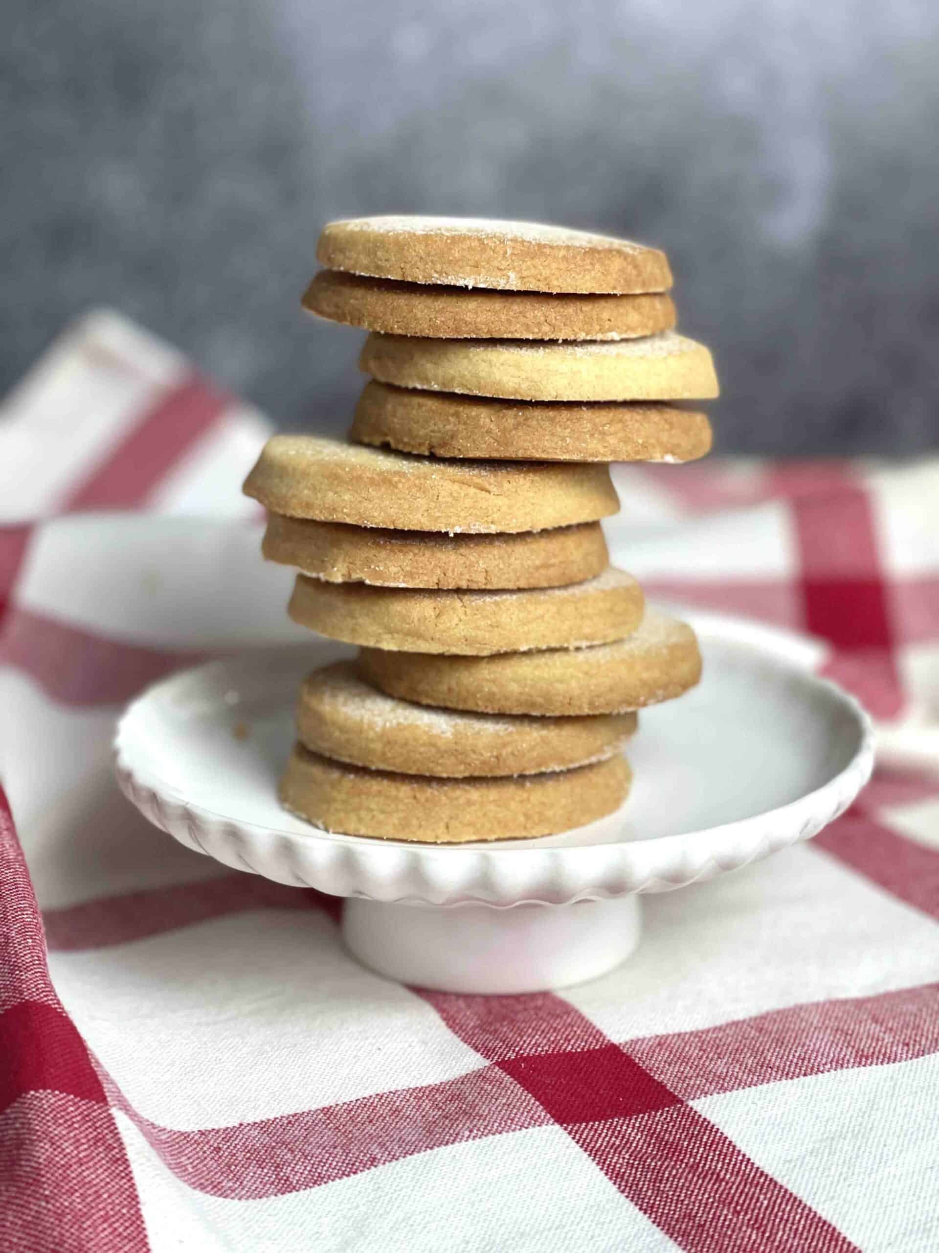 pile of sable biscuits on a plate.