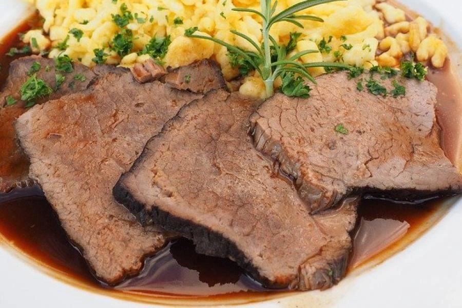 Sauerbraten in gravy with bread dumplings