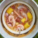 Frogmore Stew, a South Carolina specialty, featuring shrimp, sausage, corn, and potatoes, showcasing the communal dining experience
