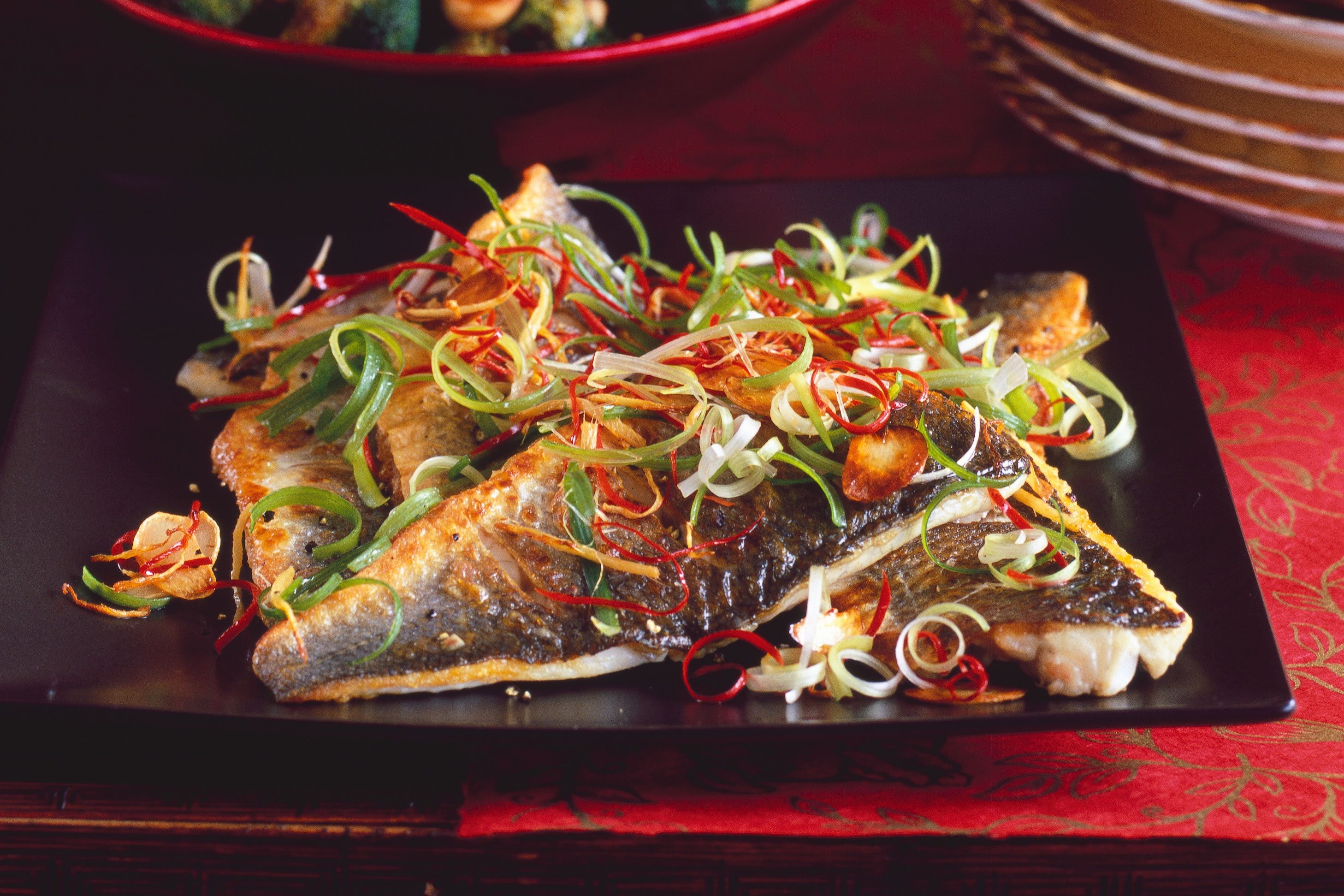 Sea bass with ginger, chili, and spring onions